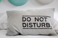 Pillow with do not disturb written on it